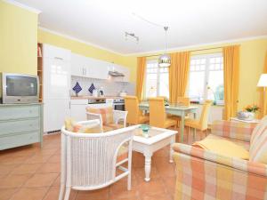 a kitchen and living room with a table and chairs at "Villa Laetitia" - WG 15 - zentral, strandnah, 2 Balkone in Binz