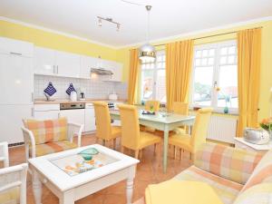 a kitchen and living room with a table and chairs at "Villa Laetitia" - WG 15 - zentral, strandnah, 2 Balkone in Binz