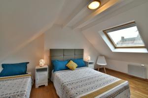 a bedroom with two beds in a attic at Gites Mont Saint Michel "AUCOEURDELABAIE" in Sains