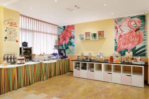 a coffee shop with a counter in a room at Viva Beach Hotel in Rimini