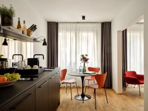 una cucina con tavolo e sedie e un tavolo di Boston Apartments HH ad Amburgo