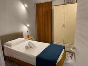 a bedroom with a bed with two towels on it at Casa Camere Pistis in Assemini