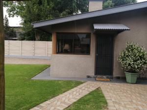 a house with a window and a grass yard at SUMMER PLACE in Harrismith