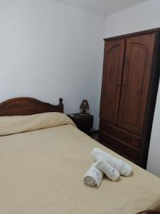 two rolled up towels sitting on a bed with a dresser at Yatale II in Chascomús +40 photos