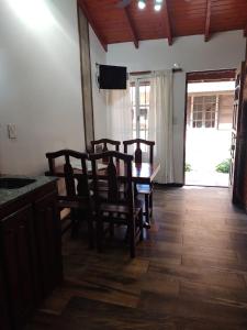 a dining room with a table and chairs and a television at Yatale II in Chascomús