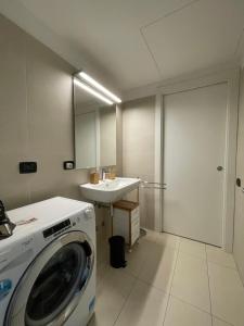 a washing machine in a bathroom with a sink at Loft Giulietta in Milan