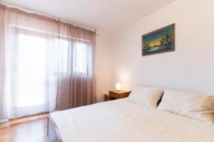 Postel nebo postele na pokoji v ubytování Beachfront apartments Calm Sea