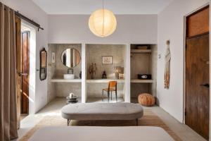 a living room with a ottoman and a mirror at DREAMCATCHER by DW in San Juan