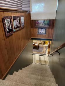 un escalier dans une maison aux murs lambrissés dans l'établissement Swan Mountain View-Private Basement Suite/10 acres, à Kalispell