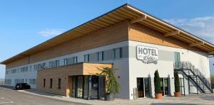 a hotel building with a sign on the side of it at Hotel am Sonnenlandpark in Lichtenau