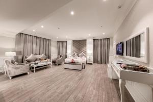 a large living room with a couch and a tv at Aswar Boutique Hotel in Al Khobar