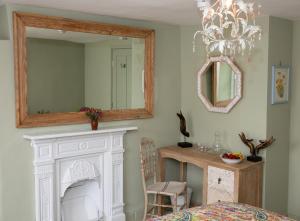 een kamer met een witte open haard en een spiegel bij SEED Hub in Wincanton