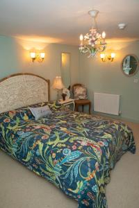 a bedroom with a bed with a colorful bedspread at SEED Hub in Wincanton