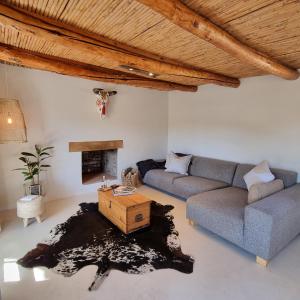 a living room with a couch and a fireplace at De Kombuys in Oudtshoorn