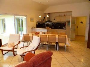 a kitchen and dining room with a table and chairs at Villa de 5 chambres avec piscine privee jacuzzi et jardin clos a Saint Nic in Saint-Nic