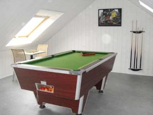 a pool table sitting in a room with at Villa de 5 chambres avec piscine privee jacuzzi et jardin clos a Saint Nic in Saint-Nic