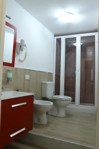 a bathroom with two sinks and a toilet and a shower at Daydreamer House in Catania
