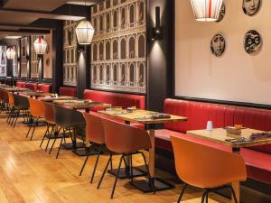 a row of tables and chairs in a restaurant at New Hotel Roblin in Paris