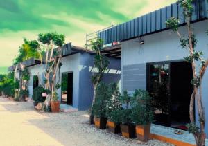 a blue building with trees in front of it at สกายวิวรีสอร์ท ชัยนาท in Ban Khao Khayai (1)