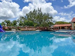 a large swimming pool with blue water at Arena Carneiros Hotel by AFT in Tamandaré