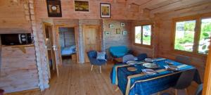 a dining room with a table in a log cabin at Bungalow vert corail in Le Vauclin