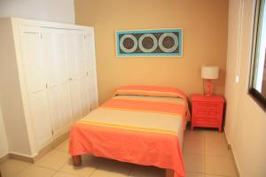 a bedroom with two twin beds and a red nightstand at Amapas Apartments Puerto Vallarta in Puerto Vallarta +27 photos