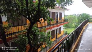 a building with balconies next to a river at The Lumbini Village Lodge in Rummindei