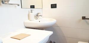 a white bathroom with a sink and a mirror at Charming country house by Anthea Homes in Casale sul Sile +22 photos