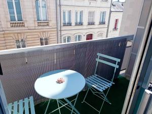 a balcony with a table and two chairs on it at Charmant Studio Refait à neuf Centre de Tours in Tours