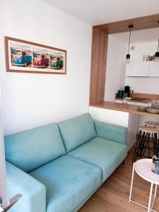 a blue couch in a room with a kitchen at Charmant Studio Refait à neuf Centre de Tours in Tours