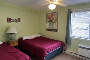 a bedroom with two beds and a window at Tree Top Getaway in Laconia