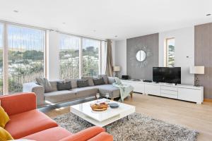 a living room with a couch and a tv at Coast at Beachdown in Bigbury