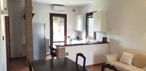 a kitchen and living room with a table and a couch at Charming country house by Anthea Homes in Casale sul Sile