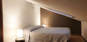 a bedroom with a bed with a sloped ceiling at Charming country house by Anthea Homes in Casale sul Sile