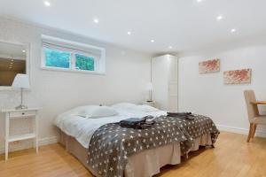 a bedroom with a bed and a table and a window at 5:ans Bed & Breakfast in Gothenburg