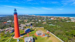 an aerial view of a red lighthouse in front of a house at The Good Ole Days King Bed Pet Friendly in Daytona Beach