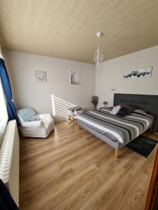 a bedroom with a bed and a couch in it at Villa Beau Site in Saint-Maurice