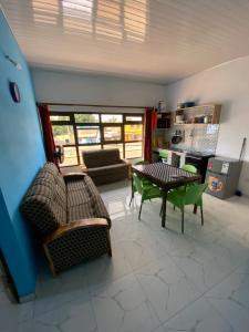 a living room with a table and chairs and a couch at Appartements Lome Marie Antoinette in Atigan