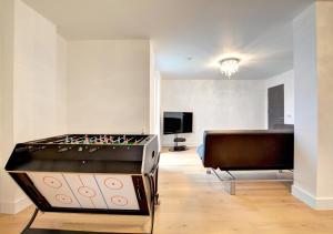 a living room with a pool table and a couch at Orion in Brighton & Hove