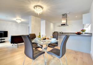 a dining room and kitchen with a table and chairs at Orion in Brighton & Hove