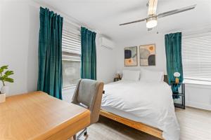 a bedroom with a bed and a desk and a table at 18th Street E in Boise