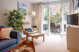 a living room with a couch and a tv and a table at Number Two in Southampton