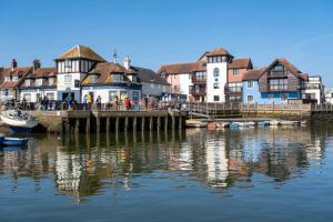 a group of houses on a pier next to a body of water at Number Two in Southampton
