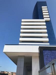 een hoog gebouw met een blauwe lucht op de achtergrond bij Kariris Blue Tower in Crato