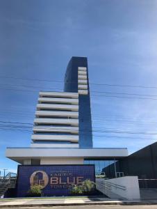 ein hohes Gebäude mit einem Schild davor in der Unterkunft Kariris Blue Tower in Crato