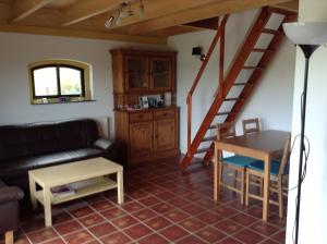 ein Wohnzimmer mit einem Sofa und einem Tisch in der Unterkunft Boerderij De Vrije Geest in Toldijk