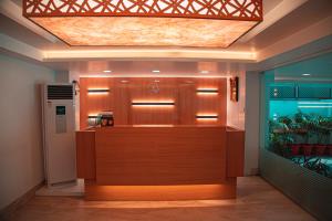 a lobby with a bar with a fish tank in it at Park Avenue Suites in Coimbatore