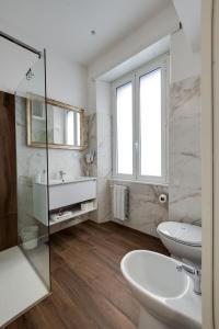 a white bathroom with a sink and a toilet at CLASSIC FLAT boschetto in Rome