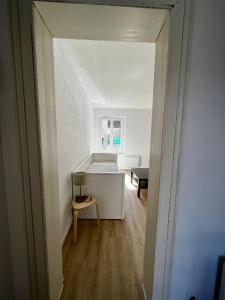 a hallway with a room with a table and a chair at Appartement Centre ville Le Havre in Le Havre