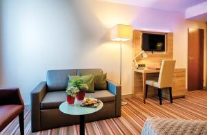 TV a/nebo společenská místnost v ubytování Leonardo Hotel Hamburg Stillhorn